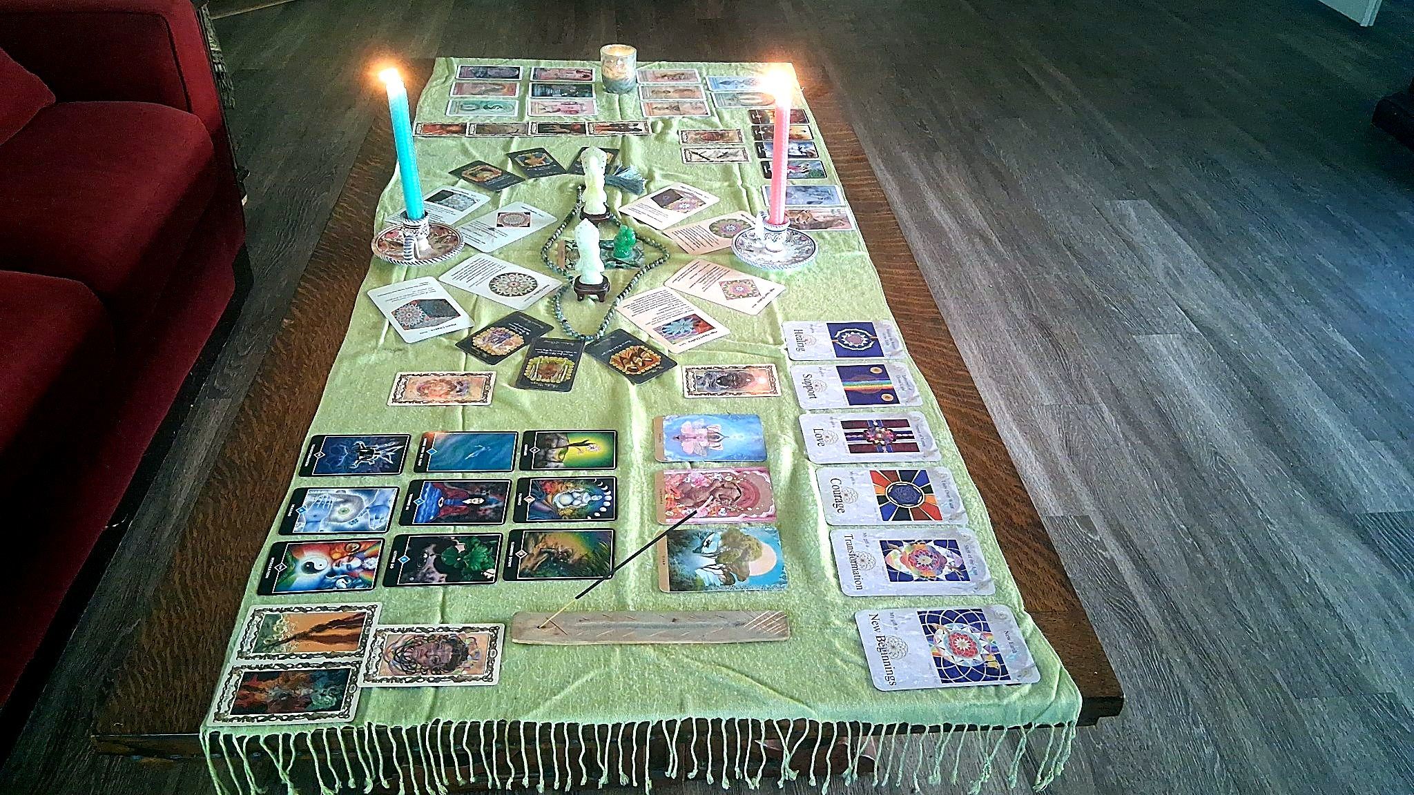 A personalized altar by Christine, with candles, prayer beads and intention cards
