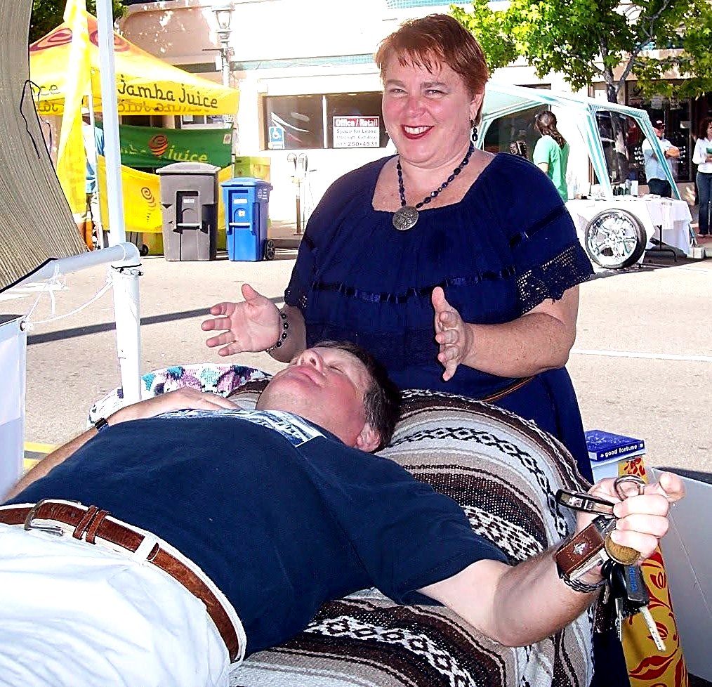 Rev. Christine performing healing work at a street fair