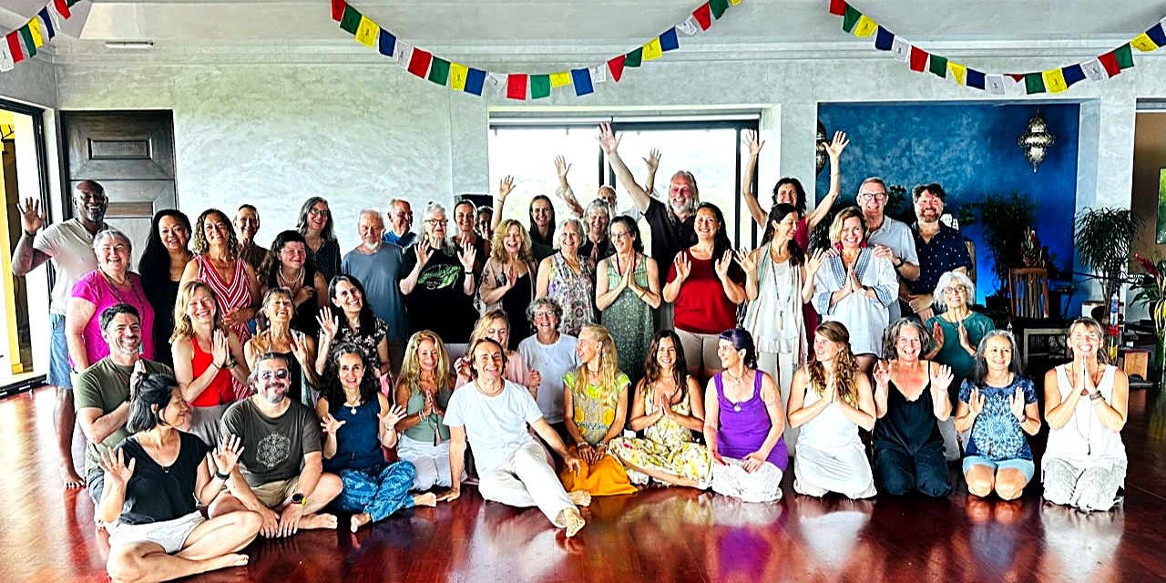 A large group of retreat participants posing together indoors at Blue Spirit, Costa Rica