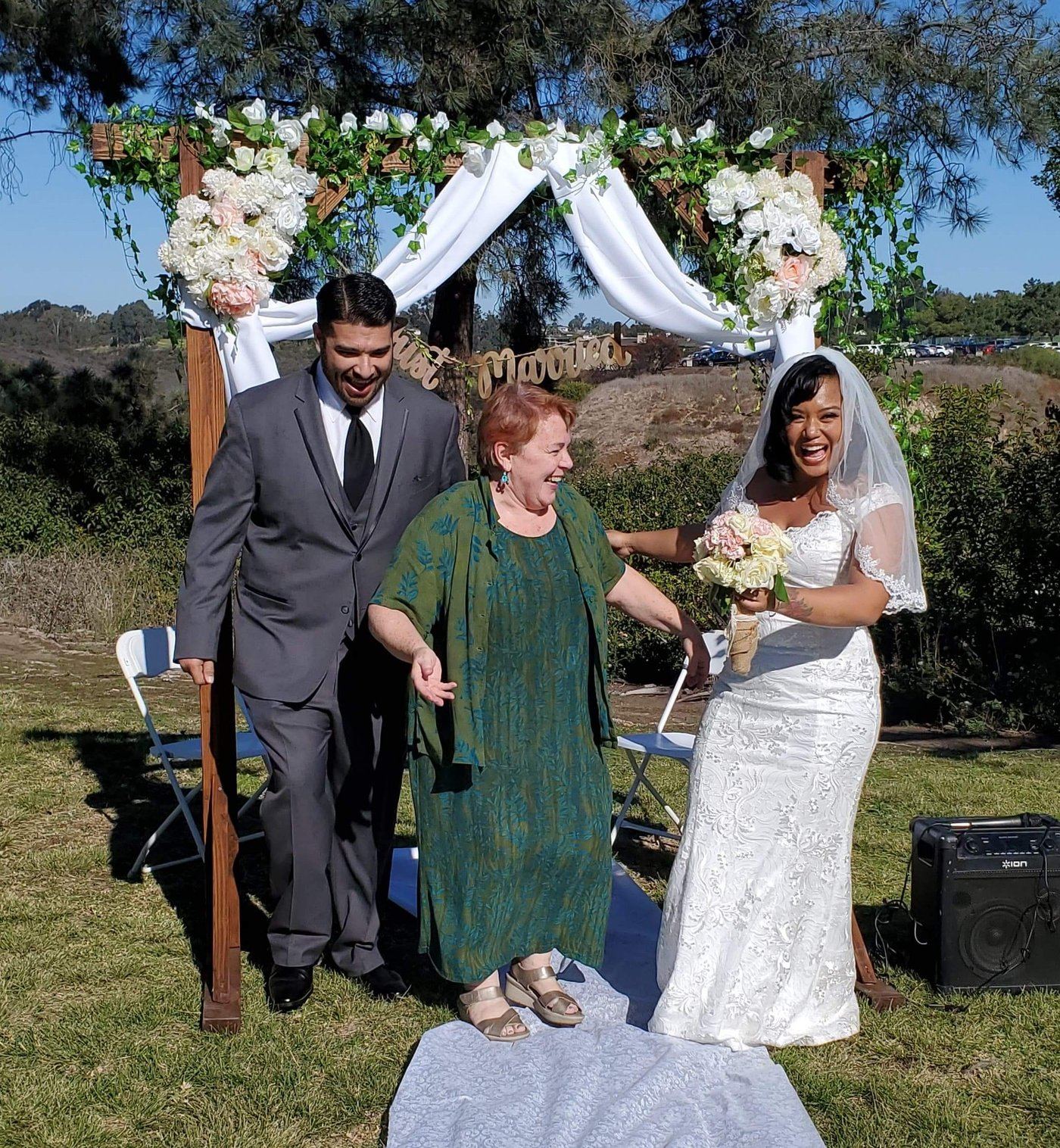 Rev. Christine celebrating with a couple moments after their outdoor wedding ceremony